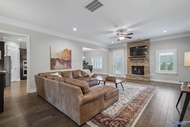 The spacious area offers plenty of room to relax and entertain, while the cozy fireplace serves as a stunning focal point.