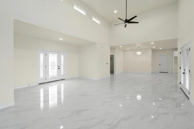 Unfurnished room featuring baseboards, a high cei