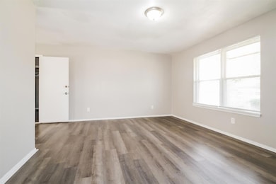Empty room with dark wood-style flooring
