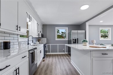 Kitchen with light wood-type flooring, sink, decor