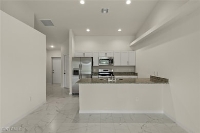 Kitchen with appliances with stainless steel finis
