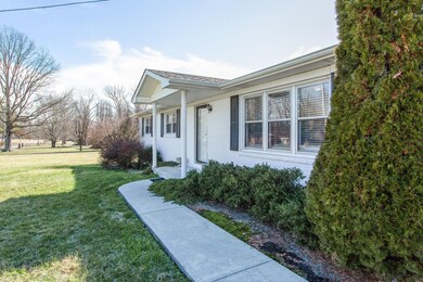 Convenient front sidewalk leads to the covered front porch.