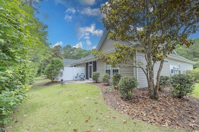 Rear view of property with a patio and a lawn