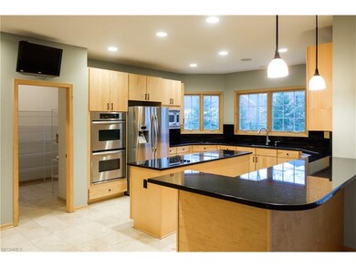 The kitchen has stainless steel appliances and a w