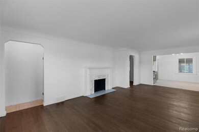 Unfurnished living room featuring arched walkways, dark wood-style flooring, and a fireplace