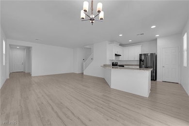 Kitchen featuring recessed lighting, a chandelier,