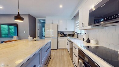 Kitchen featuring light wood-style flooring, stain