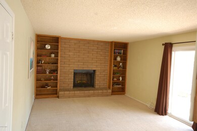 wood fireplace w/ built in book cases