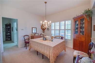 The bright formal dining room is open to the spaci