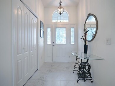 Wonderful light & bright entryway with leaded glass and palladium window above, and a large coat closet too!