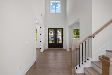 Two story foyer and double doors