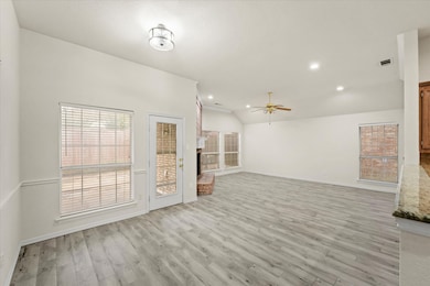Unfurnished living room with light wood-style flooring, a ceiling fan, lofted ceiling, and recessed lighting