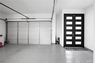 Garage featuring french doors and baseboards