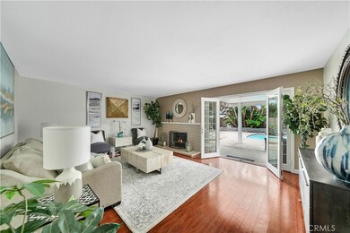 Living Room with Fireplace and French Doors Opening to the Entertainer's Backyard. French Door also has Sidelights that Open for Great Air-Flow.