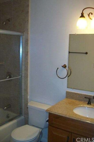 Granite counters and tile flooring in the bathroom