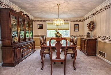 Formal dining room has chair rail wood design and 