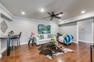 Living room with ceiling fan & built-in bar or des