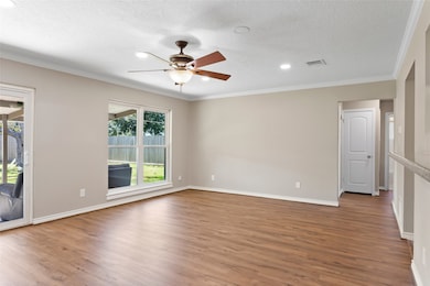 Stylish ceiling fan and crown molding add character to the spacious family room!