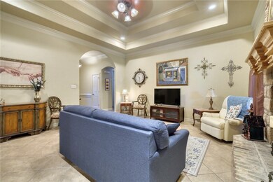 Living room featuring arched walkways, ornamental