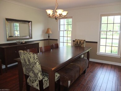 Dining room with hardwood floor, chair rail, crown
