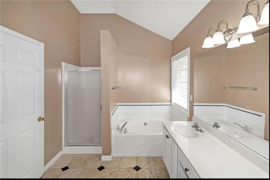 Bathroom with lofted ceiling, a shower stall, a ba