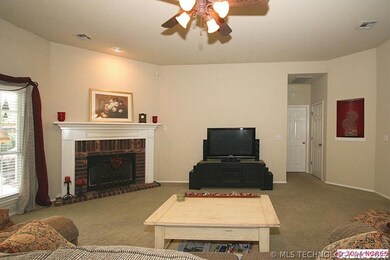 Family room has a pretty  brick fireplace