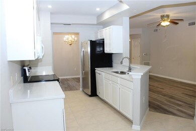 Kitchen with light tile patterned flooring, white 