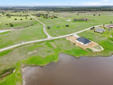 Birds eye view of property with a water view and a