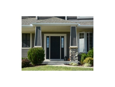 Welcoming front porch with stone trim.