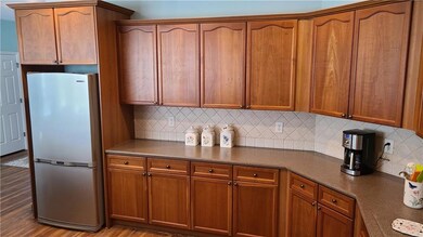 Kitchen featuring light wood-style flooring, dark 