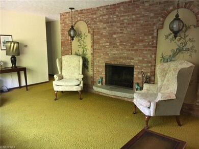 Formal living room with wood burning fireplace. Th