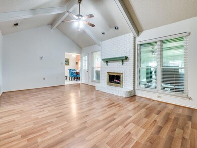 Unfurnished living room with a ceiling fan, beam c