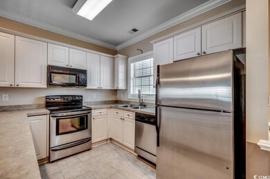 Kitchen with light tile patterned floors, stainles