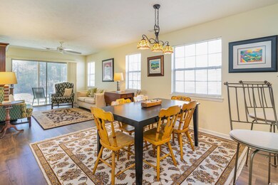 Dining room with a ceiling fan, wood finished floo