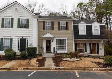 View of front of house with uncovered parking and a chimney