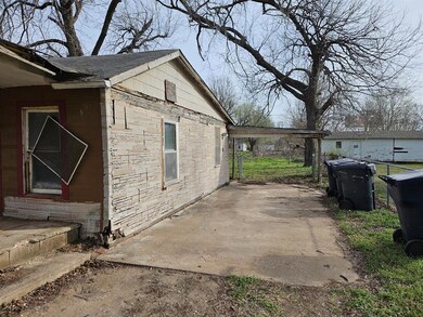 Bungalow-style house with fence