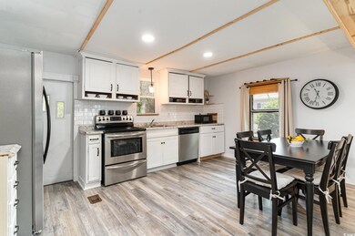 Kitchen with white cabinets, light wood-type floor