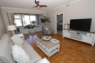 Living room with ceiling fan and crown molding