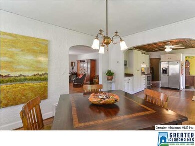 Two walls of windows flood the dining room with na