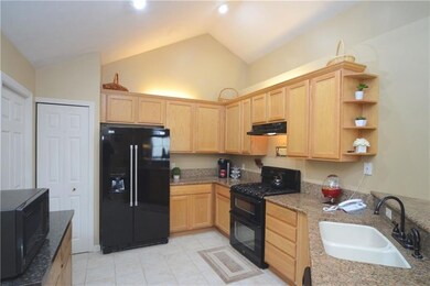The kitchen offers granite countertops and a ceram