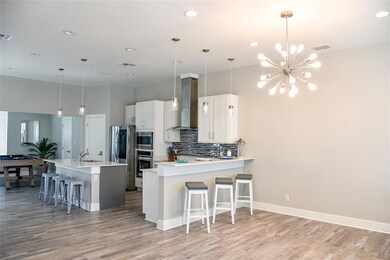 Kitchen featuring visible vents, a sink, stainless