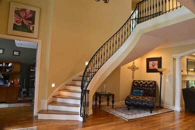 Elegant rounded staircase sets the tone of this be