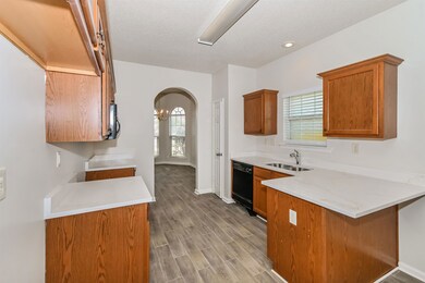 Kitchen featuring brown cabinetry, a healthy amoun