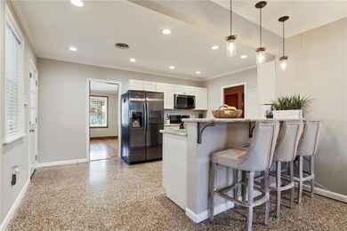 View from the den into the kitchen and dining room