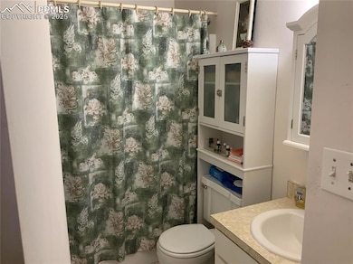 Main level Bathroom with vanity and toilet
