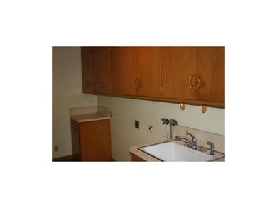 First floor laundry room with sink and built-ins