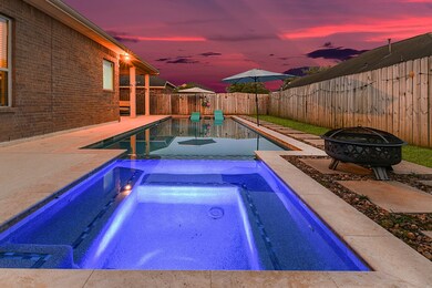 Feast your eyes on the newer square-shaped pool, showcasing captivating color-changing lights that illuminate the water in a mesmerizing display. Adorned with a stylish glass tile design, this pool exudes elegance and sophistication. Surrounding the pool and patio area is cool decking, providing a sleek and durable surface for relaxation and entertainment.