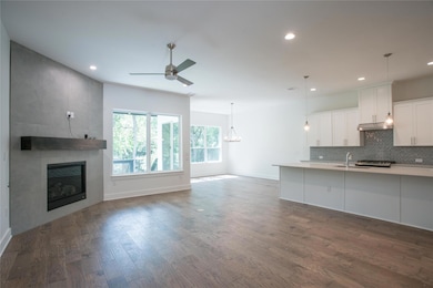 Kitchen with ceiling fan with notable chandelier,