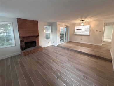Unfurnished living room featuring wood-type floori