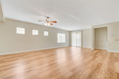 Empty room featuring ceiling fan, light wood finis